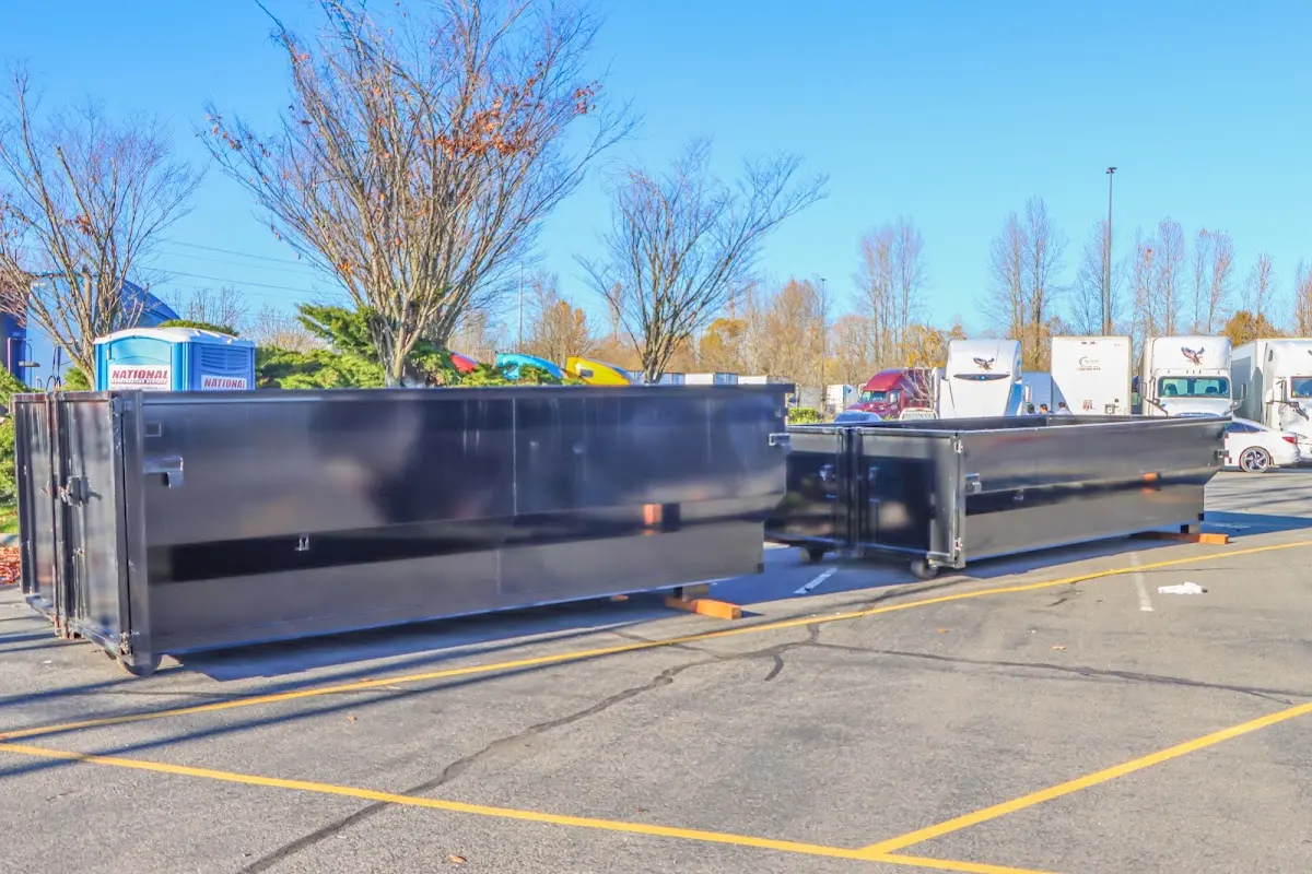 Professional dumpster rental service with roll-off container on residential driveway in Mendon